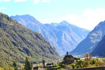 Scenic view of mountains and buildings against sky