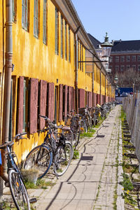 Bicycles parked on street against buildings