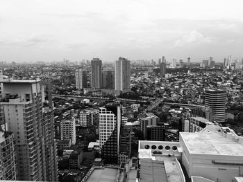 High angle view of modern buildings in city against sky