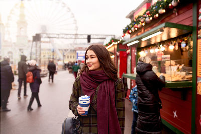 Pretty woman holding reusable coffee cup