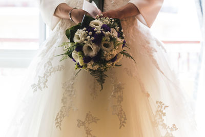 Midsection of woman holding bouquet