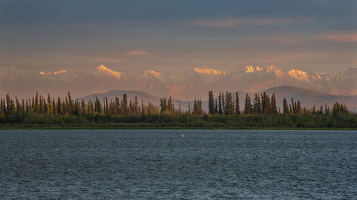 Scenic view of lake against sky during sunset