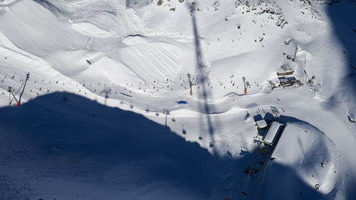 Aerial view of cable car road and long shadows in sunny austrian alps in winter