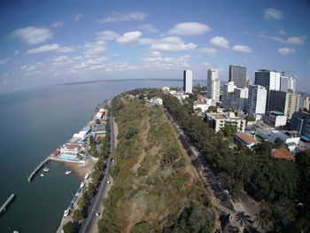 High angle view of buildings by sea against sky