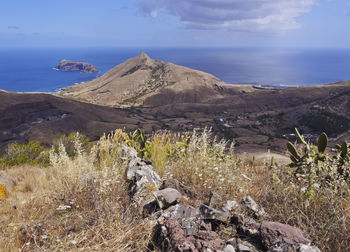 Scenic view of sea and mountains against sky