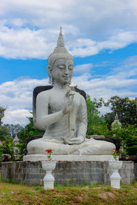 Statue of buddha against sky