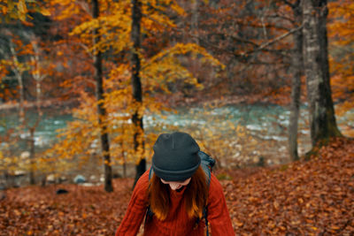 Man wearing hat in forest during autumn