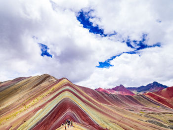 Low angle view of mountain against cloudy sky