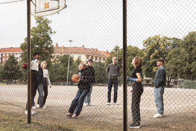 Teenagers playing basketball