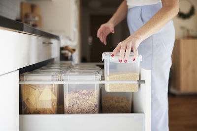 Woman's hands cleaning kitchen drawer