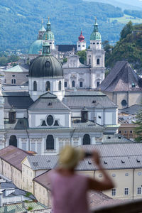 Silhouette of a tourist in front of old town of salzburg, austria