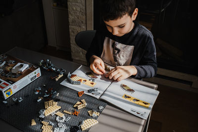 21.03.2022. batumi, georgia. boy child manually folds lego constructor at the table. star wars. l