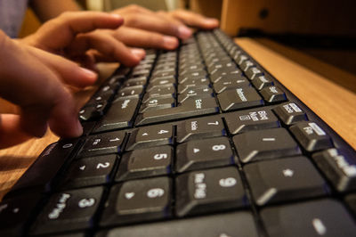 Cropped hands of people typing on computer keyboard