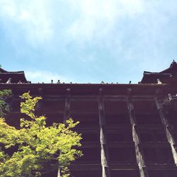 Low angle view of building against cloudy sky