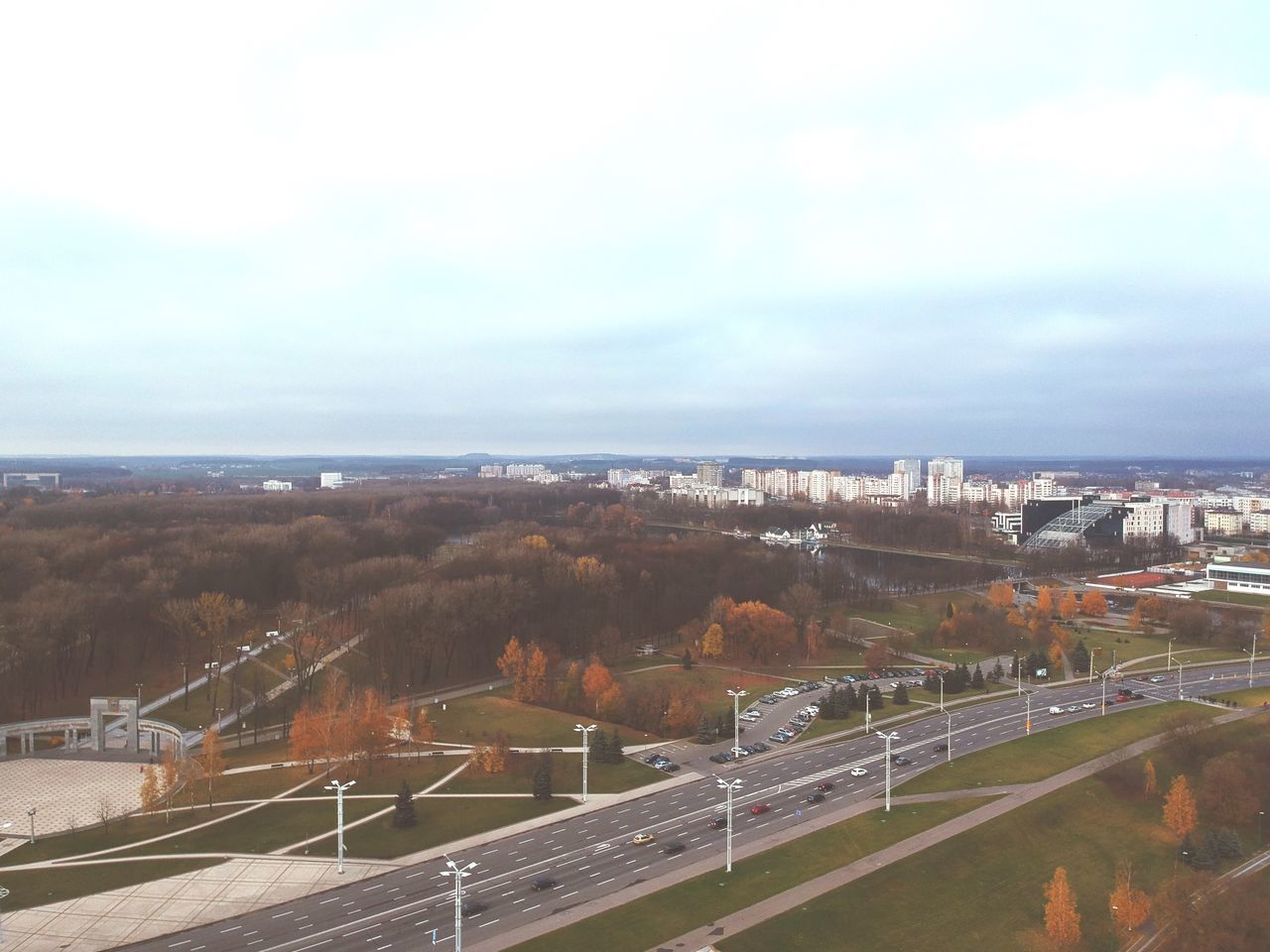 HIGH ANGLE VIEW OF ROAD BY BUILDINGS AGAINST SKY