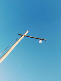 Low angle view of street light against clear blue sky