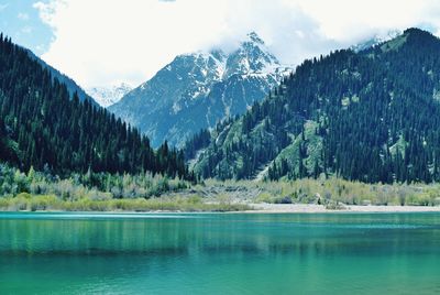 Scenic view of lake and mountains against sky