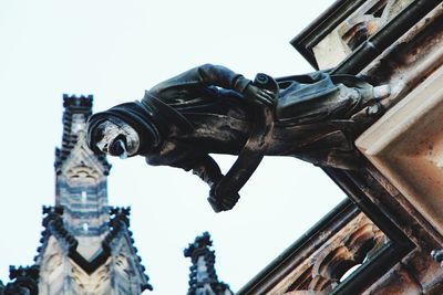 Low angle view of statue against building