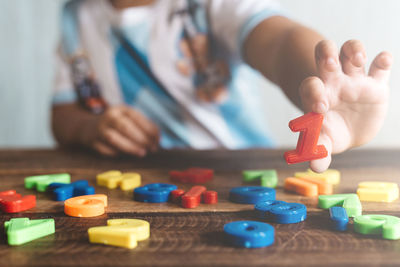 Midsection of person playing with toy toys