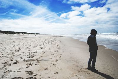 Rear view of man standing on beach