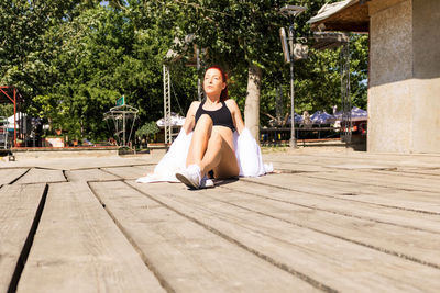 Young redhead woman sunbathing during summer vacation.