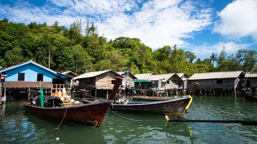 Boats moored in lake against sky