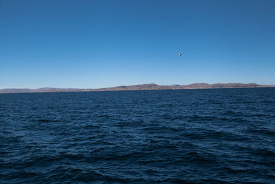 View of sea against clear blue sky