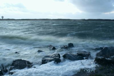 Scenic view of sea against cloudy sky