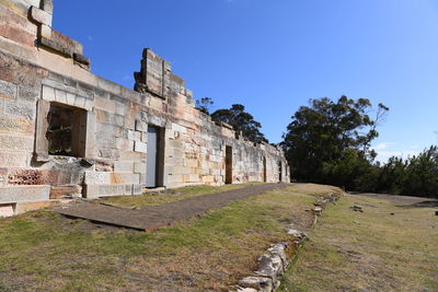 Old ruin building against blue sky