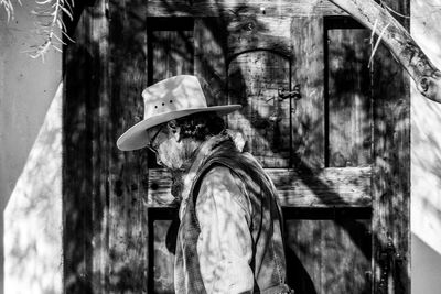 Portrait of man with umbrella on built structure