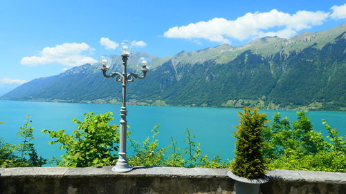 Scenic view of lake by mountains against sky