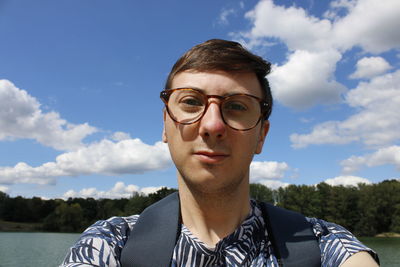 Portrait of young man against sky