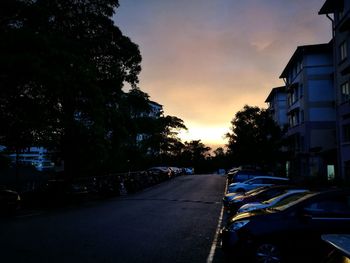 Cars on road in city against sky