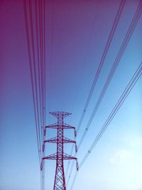 Low angle view of electricity pylon against clear sky