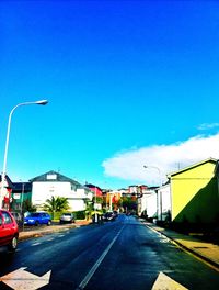 Empty road along buildings