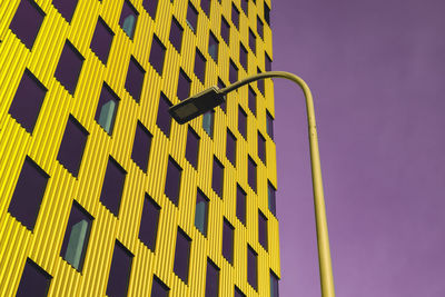 Modern office building exterior with glass facade on purple sky background. vivid colors transparent