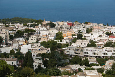 High angle view of townscape by sea