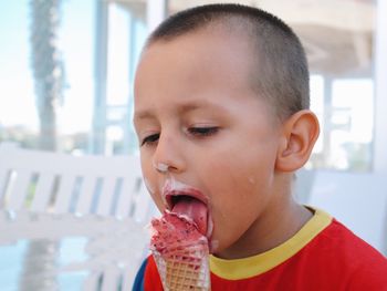 Close-up of cute boy eating ice cream