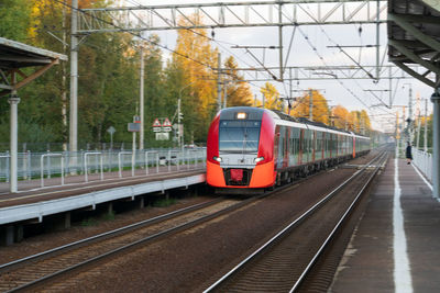 Modern intercity high speed train at sunset. commercial suburban railroad transportation concept.