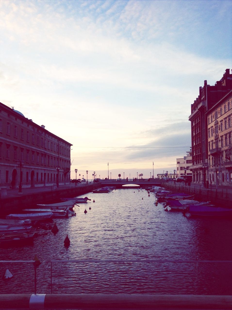 architecture, building exterior, built structure, water, sky, waterfront, city, canal, river, transportation, nautical vessel, residential structure, cloud - sky, travel destinations, building, residential building, cloud, incidental people, rippled, travel