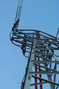 Low angle view of crane against clear sky