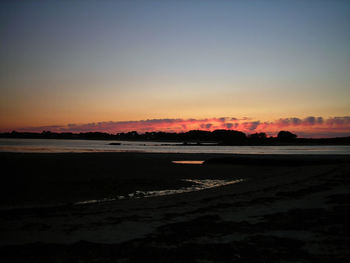 Scenic view of beach against sky during sunset