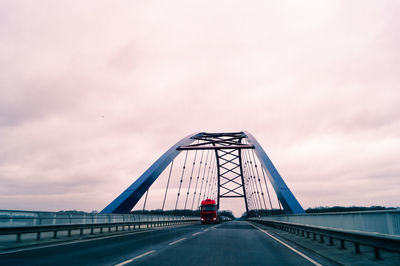 Truck on bridge at sunset