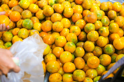 High angle view of oranges in market for sale
