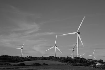 Low angle view of windmill against sky