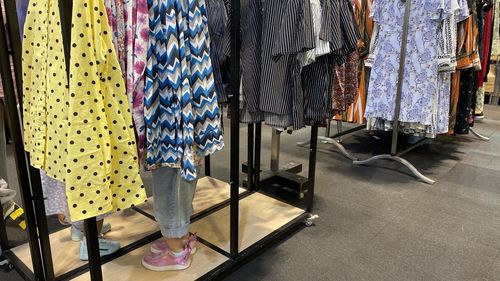 Low section of women standing on display at store