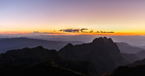 Scenic view of silhouette mountains against sky during sunset