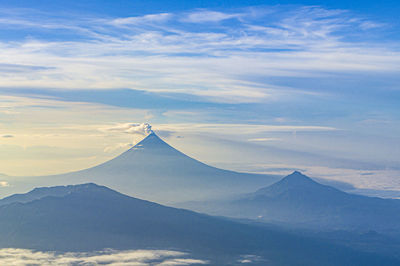 Scenic view of snowcapped mountains against cloudy sky