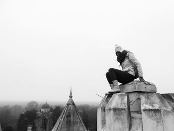Man sitting against clear sky