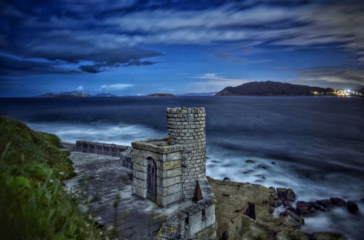 SCENIC VIEW OF SEA AGAINST BUILDINGS AND SKY